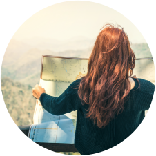 Red haired woman reading a road map